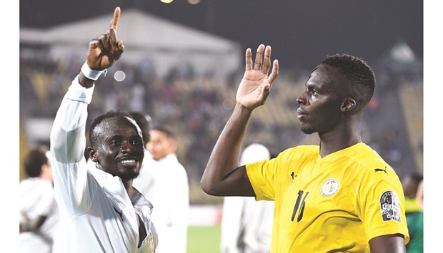 Senegalu2019s forward Sadio Mane (left) and goalkeeper Edouard Mendy celebrate after their victory against Burkina Faso in the Africa Cup of Nations semi-final at the Stade Ahmadou-Ahidjo in Yaounde on Wednesday. (AFP)