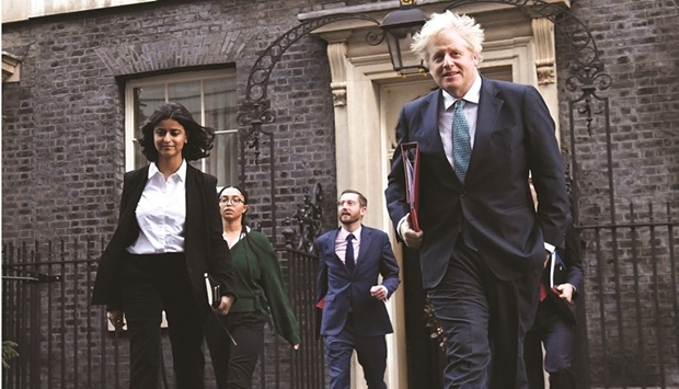 Britainu2019s Prime Minister Boris Johnson leaves 10 Downing Street in London with Director of the Number 10 Policy Unit Munira Mirza (left) to attend the weekly cabinet meeting in a file picture.