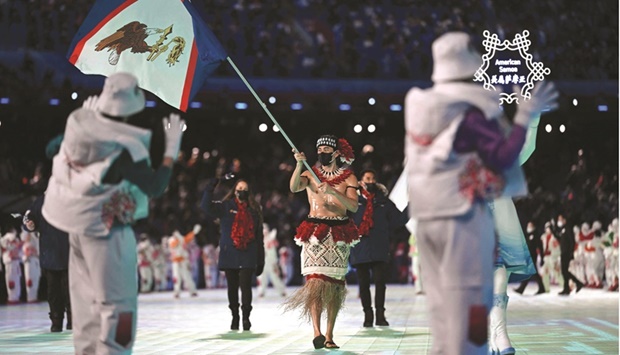 American Samoau2019s flag bearer Nathan Crumpton takes part in the parade of athletes during the opening ceremony of the Beijing Winter Olympic Games. (AFP)