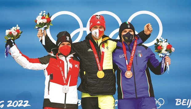 Gold medallist Johannes Ludwig of Germany celebrates on the podium with silver  medallist, Wolfgang Kindl of Austria and bronze winner Italyu2019s Dominik Fischnaller after the luge competition at the National Sliding Centre in Beijing, China, yesterday. (Reuters)