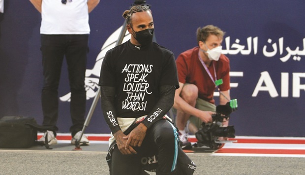 Mercedesu2019 Lewis Hamilton kneels in support of the Black Lives Matter campaign on the grid before the Bahrain Grand Prix at Bahrain International Circuit, Sakhir, on March 28, 2021. (Reuters)