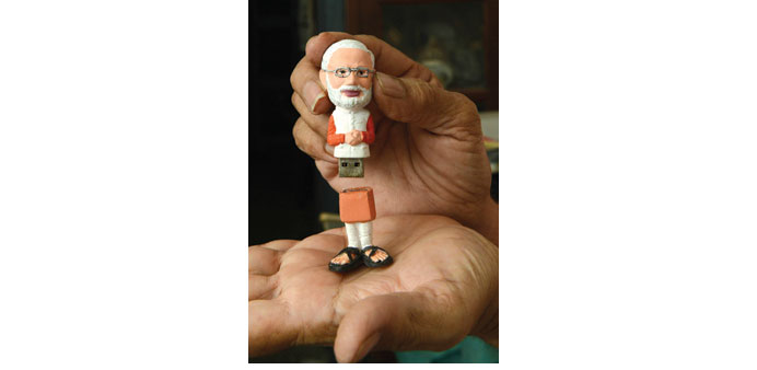 A pen drive in the image of Narendra Modi is shown during a launch ceremony by the u2018Gujarat Gaurav Fan Clubu2019 (GGFC) in Ahmedabad yesterday.