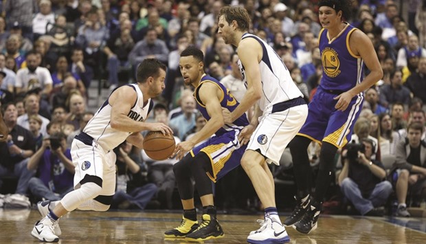 Dallas Mavericks guard J.J. Barea  drives around Golden State Warriors guard Stephen Curry  and forward Dirk Nowitzki during their NBA game on Friday. Picture: Tim Heitman-USA TODAY Sports