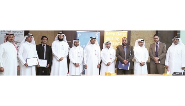 Representatives of some of the organisations which received Certificates of Appreciation from Kahramaa yesterday are seen with Conservation and Energy Efficiency Department manager and senior engineer Abdul Azeez al-Hammadi (centre). PICTURE: Jayan Orma