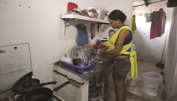 Daniele Santos with her baby Juan Pedro in her home in Recife, Brazil.