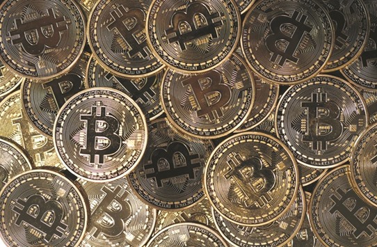 A collection of bitcoin tokens are displayed in London. While speculators continue to push the value of the digital money to record highs against the US dollar, the system that verifies bitcoin transactions, known as the blockchain, is more backlogged than at any point in the currencyu2019s eight-year history.