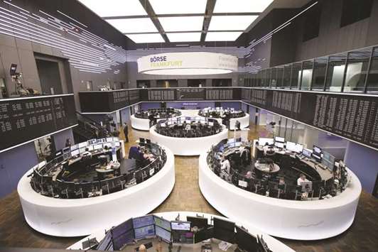 Traders monitor financial data inside the Frankfurt Stock Exchange. The DAX fell 2.2% at 12,158.70 points yesterday.