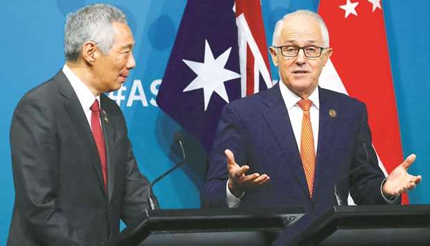 Australian Prime Minister Malcolm Turnbull (right) and Prime Minister of Singapore Lee Hsien Loong at a media conference during the one-off summit of 10-member Association of Southeast Asian Nations in Sydney yesterday. u201cYou donu2019t grow stronger by closing the door to other markets. Protectionism is a dead end. It is not a ladder to get you out of the low growth trap, it is a shovel to dig it much deeper,u201d Turnbull said.