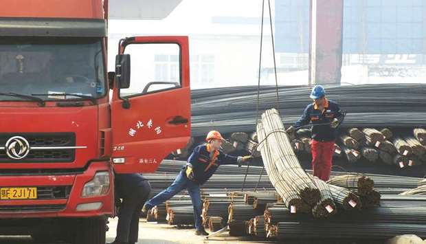 Labourers working at a steel market in Yichang, Hubei province. China called on the US yesterday to u201cexercise restraint in using trade protection toolsu201d after President Donald Trump announced plans to impose new tariffs on steel and aluminium.