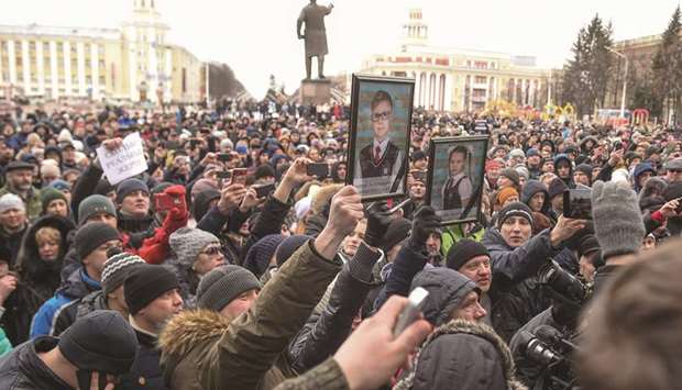 People gather to pay tribute to the victims of the shopping centre fire in Kemerovo.