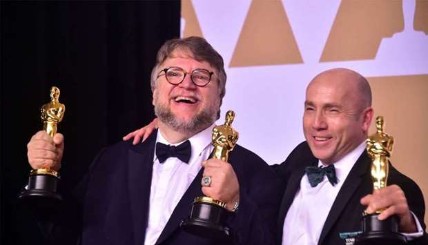 Producer and director Guillermo del Toro (L) and producter J. Miles Dale pose in the press room with the Oscar for best picture and best director for their film The Shape of Water during the 90th Annual Academy Awards on March 4, 2018, in Hollywood, California.