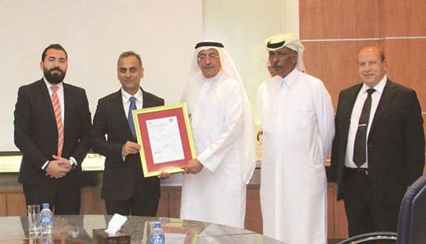 Teyseer Motors president Adel al-Mannai receives the certification from British ambassador Ajay Sharma during a recently-held awards ceremony.