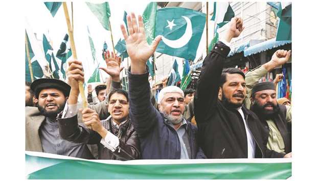 People raise their hands as they chant slogans to show solidarity with Pakistan Armed Force in a rally in Peshawar yesterday.