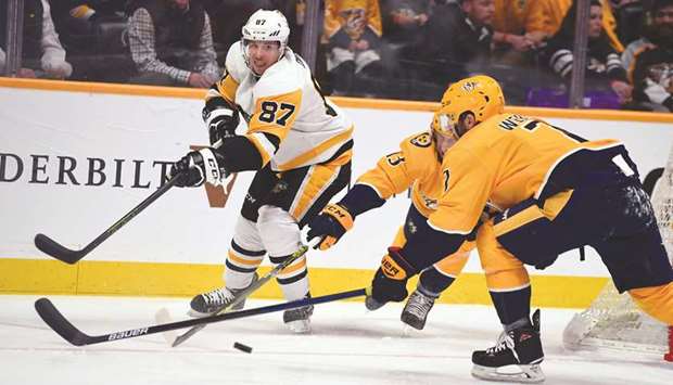 Pittsburgh Penguinsu2019 Sidney Crosby (left) passes the puck as Nashville Predatorsu2019 Nick Bonino (centre) and Yannick Weber defend during the NHL game in Nashville, USA, on Thursday. (USA TODAY Sports)