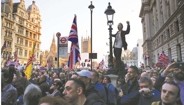 A pro-Brexit protester shouts slogans while holding onto a lamppost outside the Houses of Parliament in London on Friday. Prime Minister Theresa Mayu2019s deferral of the departure to at least April 12 came too late for companies that spent months assuming the crunch would arrive as scheduled. If London and Brussels delay further to avoid a chaotic no-deal split, some of the preparations could turn out to have been for naught.