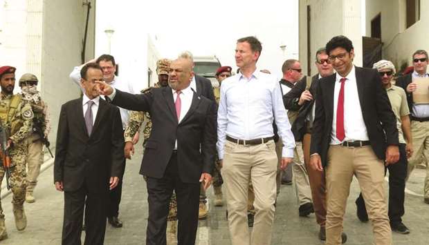 Yemenu2019s Foreign Minister, Khaled al-Yamani gestures as he walks with British Foreign Secretary, Jeremy Hunt, at the presidential palace in Aden, yesterday.