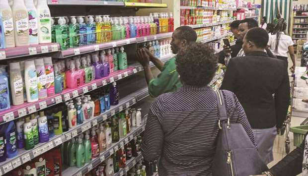 People stand in an aisle to buy liquid soaps after the stock of disinfectants ran out at supermarkets in Kenya in Nairobi, yesterday.