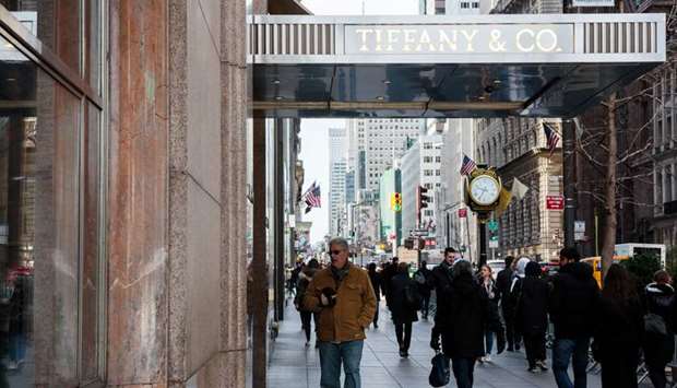 Pedestrians pass in front of the Tiffany & Co flagship store on Fifth Avenue in New York. The Commerce Department said yesterday consumer spending increased 0.2% last month as households spent more on electricity and gas, offsetting decreases in outlays on motor vehicles and parts as well as recreational goods.