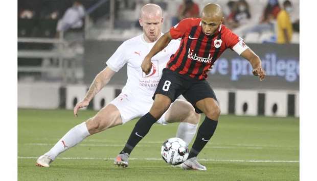 Al Rayyan's Yacine Brahimi (R) vies for the ball with Al Arabi's Aron Gunnarson during their QNB Sta