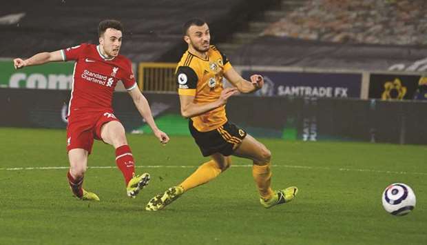 Liverpoolu2019s Diogo Jota (left) scores against Wolverhampton Wanderers during the Premier League match on Monday night. (AFP)