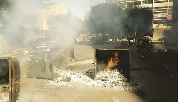 Burning garbage dumpsters block a main road in the Lebanese capital Beirut after anti-government demonstrators set them on fire in protest against the deteriorating economic situation on Tuesday. Lebanonu2019s worst economic downturn in decades has pushed a battered population to the brink with no solution in sight as the countryu2019s barons wrangle over forming a new government.