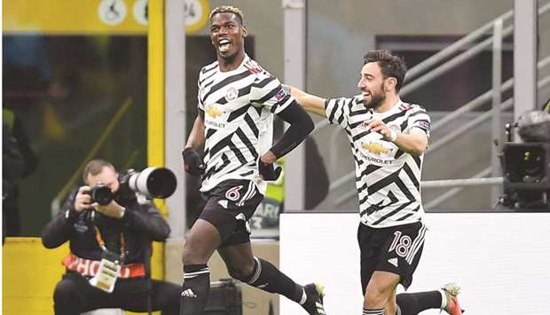 Manchester Unitedu2019s Paul Pogba (left) celebrates with Bruno Fernandes after scoring against AC Milan during the Europa League last 16 second leg match at the San Siro in Milan, Italy on Thursday night. (Reuters)