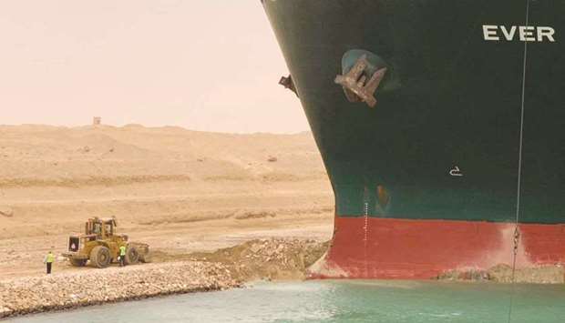 A handout picture released by the Suez Canal Authority yesterday shows a part of the Taiwan-owned MV Ever Given (Evergreen), a 400-metre long and 59-metre wide vessel, lodged sideways and impeding all traffic across the waterway of Egyptu2019s Suez Canal.