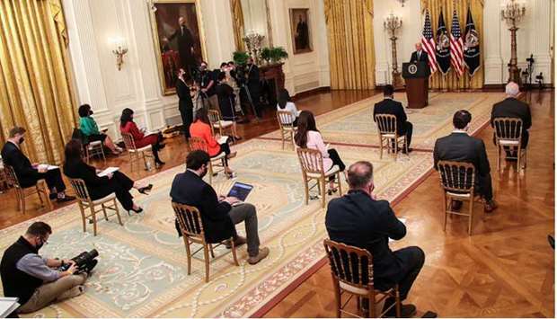 Socially-distanced reporters are seen as US President Biden holds his first formal news conference in the East Room of the White House in Washington.