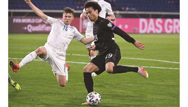 Icelandu2019s Alfons Sampsted (left) and Germanyu2019s Leroy Sane vie for the ball during the World Cup 2022 qualification match in Duisburg, western Germany. b(AFP)