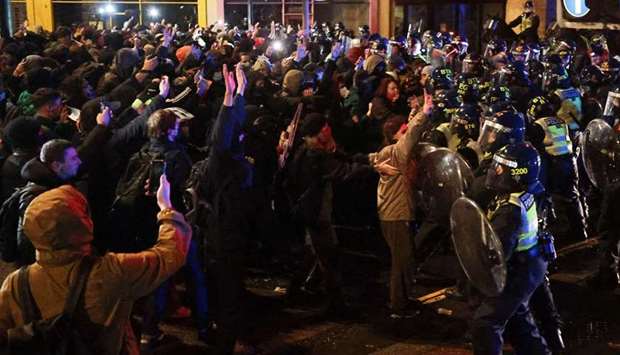 Police officers clash with demonstrators during a protest against a newly proposed policing bill, in Bristol, Britain