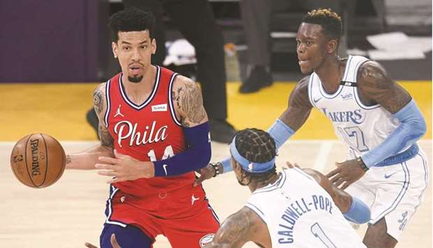 Danny Green (left) of the Philadelphia 76ers looks to pass as he is guarded by Dennis Schroder (right) and Kentavious Caldwell-Pope of the Los Angeles Lakers during the game at Staples Center in Los Angeles, United States, on Thursday. (AFP)