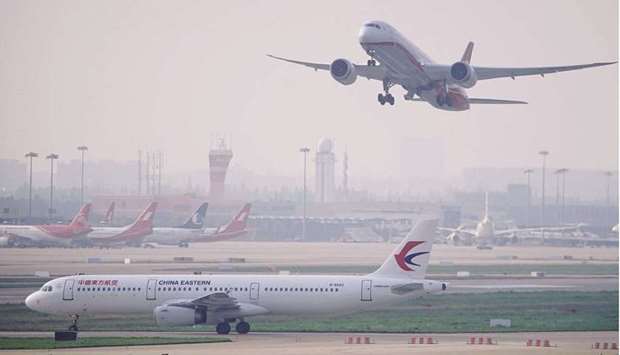 A China Eastern Airlines aircraft and  Shanghai Airlines aircraft are seen in Hongqiao International Airport in Shanghai (file). The Chinese domestic market quietly overtook the once-dominant US market in size during the pandemic, but multiple coronavirus outbreaks before last monthu2019s Lunar New Year halted the rebound and could lead to first-quarter losses.