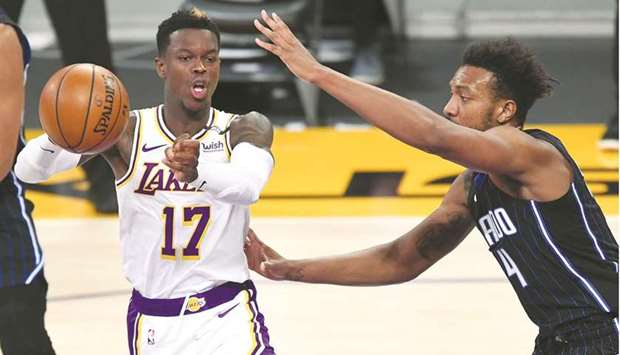 Los Angeles Lakers guard Dennis Schroder makes a pass as he is defended by Orlando Magic guard Karim Mane in the first-half at Staples Center in Los Angeles, California. (USA TODAY Sports)