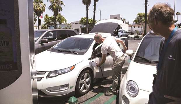 Drivers charge electric vehicles (EVs) at a Volta Industries electric charging station in Los Angeles. Biden is set to unveil today a $3tn or more infrastructure proposal that could include significant support for manufacturing and charging EVs.