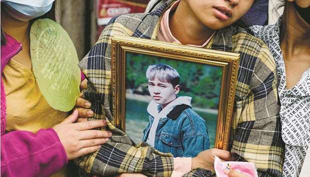 A relative holds onto the portrait of a protester, who died amid a crackdown by security forces on demonstrations against the military coup, during his funeral in Taunggyi in Myanmaru2019s Shan state.