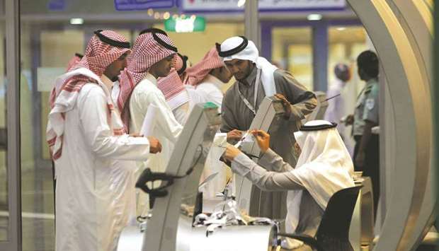 Jobseekers stand in line to talk with a recruiter at a job fair in Riyadh (file). Twenty-four of the kingdomu2019s biggest companies, including energy giant Aramco and petrochemical firm Sabic, will lead the investment drive by contributing 5tn riyals over the next decade, says Crown Prince Mohamed bin Salman.