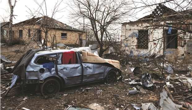 The debris of damaged houses lies on the ground near the spot where a cultural centre and  administration building once stood, destroyed during an aerial bombing in the village of Byshiv outside Kyiv yesterday. (Reuters)