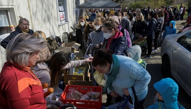 Refugees from Ukraine queue for food at a donation collection point organised by the Dresden's Ukraine Catholic parish, amid Russia's invasion of Ukraine, in Dresden, Germany on March 20. REUTERS