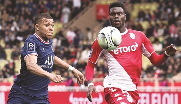 PSGu2019s French forward Kylian Mbappe (left) fights for the ball with Monacou2019s Benoit Badiashile Mukinayi during their French L1 match at the Louis II Stadium in the Principality of Monaco yesterday. (AFP)