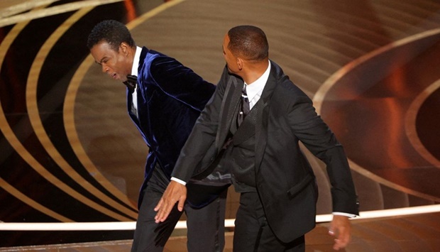 Will Smith hits at Chris Rock as Rock spoke on stage during the 94th Academy Awards in Hollywood, Los Angeles, California, U.S., March 27, 2022. 