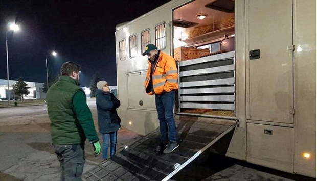 Members of Poznan Zoo stand next to a truck carrying animals from a sanctuary east of Kyiv to Poznan Zoo, as they wait at the Polish-Ukrainian border crossing Korczowa - Krakovets, Poland on March 2.