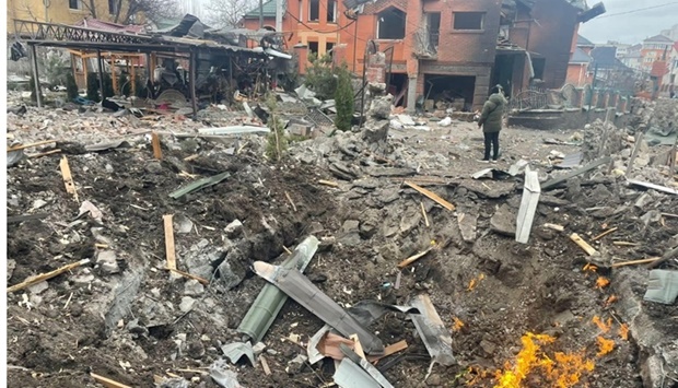 Debris are scattered around the hole in a road at the site where several houses have been damaged by an explosion, following an air strike in Bila Tserkva, Kyiv Oblast, Ukraine, in this picture obtained from social media. Kyiv Oblast Police/Handout via REUTERS