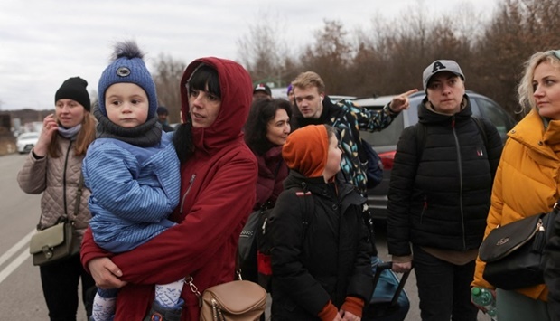 People fleeing the Russian invasion of Ukraine wait for transport after arriving in Slovakia, at a border crossing in Vysne Nemecke, Slovakia on March 5. REUTERS/Lukasz Glowala