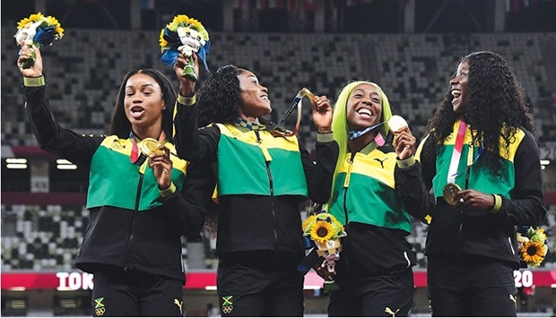 Gold medallists Jamaicau2019s Briana Williams, Jamaicau2019s Elaine Thompson-Herah, Jamaicau2019s Shelly-Ann Fraser-Pryce and Jamaicau2019s Shericka Jackson celebrate on the podium with their medals during the victory ceremony for the womenu2019s 4x100m relay event during the Tokyo 2020 Olympic Games at the Olympic Stadium in Tokyo on August 7, 2021. The sport of athletics is moving towards gender parity at its highest executive level but needs to ensure women stay in the sport beyond 18, World Athletics President Sebastian Coe has said. (AFP)