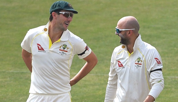 Australiau2019s Nathan Lyon and teammate captain Pat Cummins (left) speak during a break on the fifth day of the first Test against Pakistan at the Pindi Cricket Stadium in Rawalpindi yesterday. (AFP)