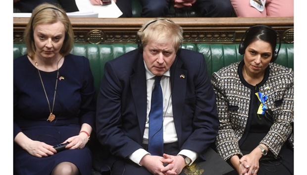 A handout photograph released by the UK Parliament shows (From L) Britain's Foreign Secretary Liz Truss, Britain's Prime Minister Boris Johnson and Britain's Home Secretary Priti Patel listening to Ukraine's President Volodymyr Zelensky speaking to them by live video-link in the House of Commons, in London, on March 8