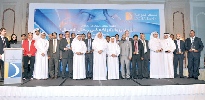 Dr R Seetharaman and other Doha Bank executives with partner merchants who were honoured by the bank recently.