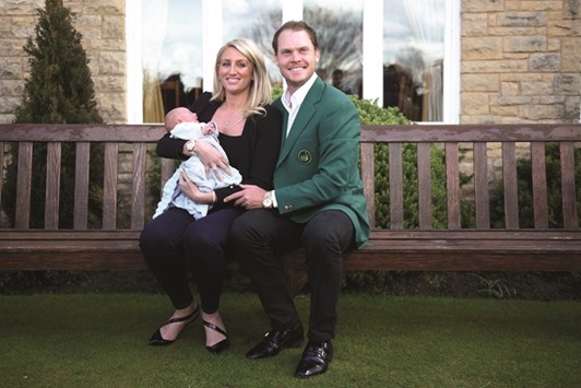 English golfer Danny Willett, wearing his Masters champion green jacket poses with his wife Nicole and newborn son Zachariah James Willett at Lindrick golf club, near Worksop, northern England yesterday. (AFP)