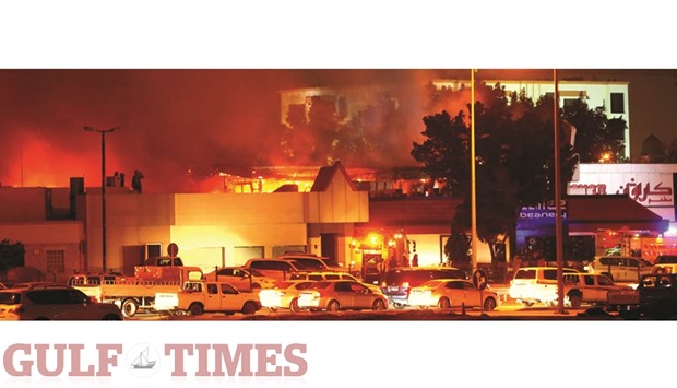 A major blaze that broke out in a portion of the popular Caravan Complex housing many restaurants, near Jabr bin Ahmed intersection (old Ramada junction) beside C Ring Road in Doha, around 7pm yesterday, was brought under control after nearly two and a half hours with reportedly no casualties. Traffic diversion caused by the fire caused congestion in the nearby roads. PICTURE: Jayan Orma