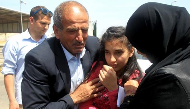 The parents of Palestinian Dima al-Wawi, 12, who is believed to be the youngest female detained by Israel, greet her in the West Bank city of Tulkarem, upon her release from Israeli prison on Sunday.